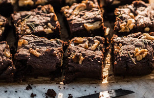 Beetroot brownies on a wooden board next to mug of tea