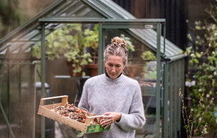 Bex Partridge outside her greenhouse