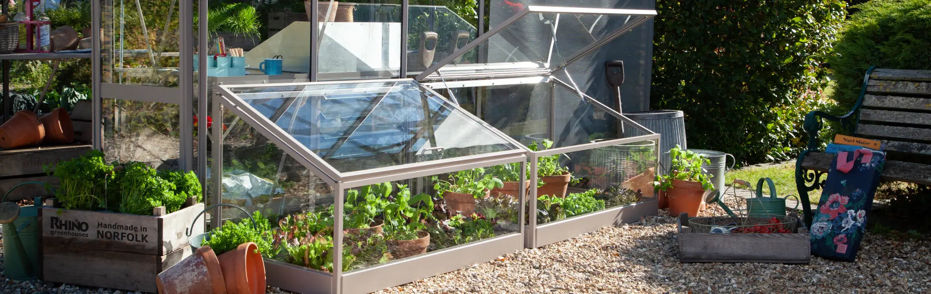 Two Rhino Cold Frames beside a greenhouse