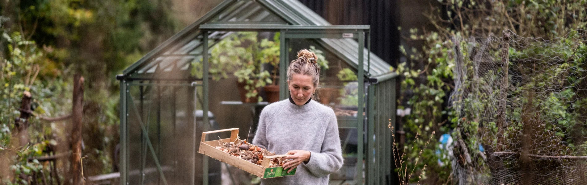 Bex Partridge outside her greenhouse