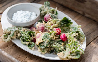Fried Radishes on a white plate ontop of a wooden tray
