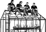 Four people, sitting on a Rhino Greenhouse roof, are engaged in conversation. One holds a newspaper, while others hold mugs. Inside the Rhino Greenhouse, plants are organized on shelves.