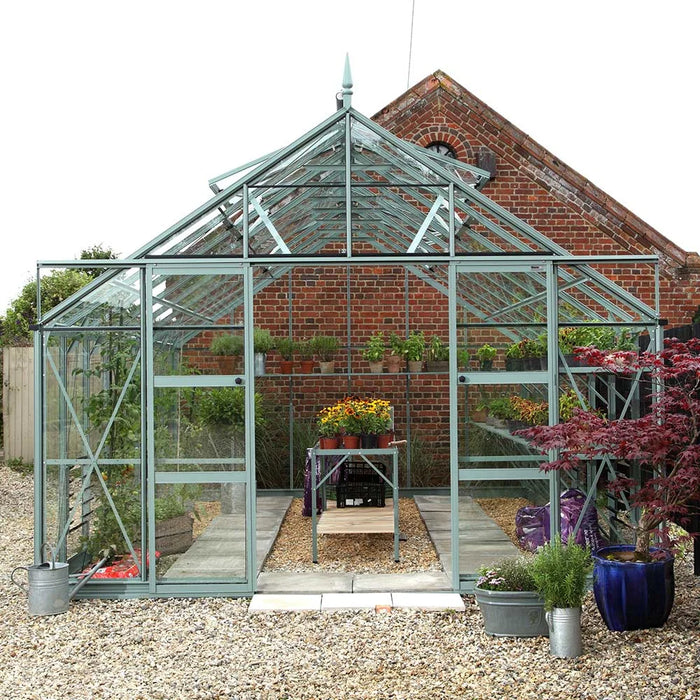 Rhino situated on gravel filled with potted plants and crops