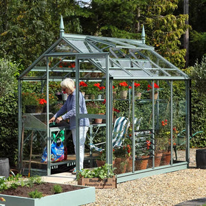 Woman potting plants inside her 6x8 Rhino Premium