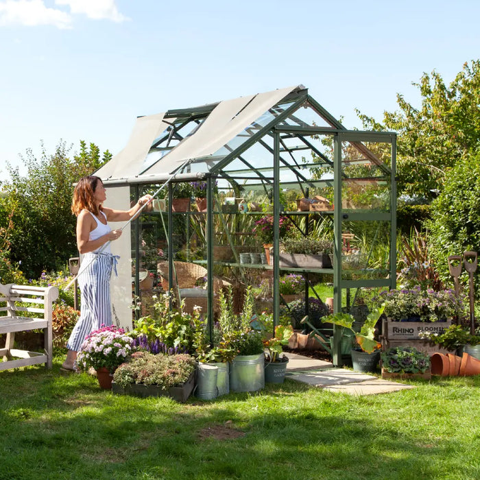 Lady pulling blinds down on her greenhouse