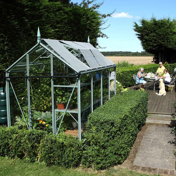 Family sat at table admiring their Rhino Greenhouse
